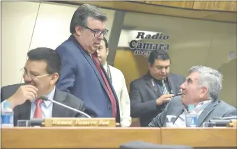  ??  ?? Los diputados Mario Cáceres (ANR, abdista) y Luis Larré (ANR, cartista) conversan en la sala de sesiones. Se despiden el 29 de junio como diputados del presente periodo.