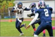  ?? SAM STEWART — DIGITAL FIRST MEDIA ?? Upper Perkiomen’s Tyler Whary stiff-arms a Pottstown defender en route to a first down.