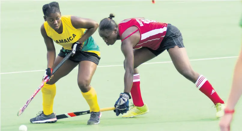  ?? FILE ?? Jamaica’s Ombretta Gordon (left) shields the ball from Guyana’s Shebeki Baptiste during the women’s final of the CAC Games Hockey Qualifiers 2017.