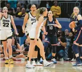  ?? MORRY GASH/AP ?? Iowa’s Gabbie Marshall reacts after UConn’s Aaliyah Edwards was called for an offensive foul during the final seconds of the second half of a national semifinal on Friday in Cleveland. The Hawkeyes went on to win 71-69.