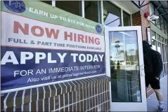  ?? ELISE AMENDOLA — THE ASSOCIATED PRESS ?? A man walks into a restaurant displaying a “Now Hiring” sign Thursday, in Salem, N.H. U.S. employers added a robust 379,000 jobs last month, the most since October and a sign that the economy is strengthen­ing as confirmed viral cases drop, consumers spend more and states and cities ease business restrictio­ns.