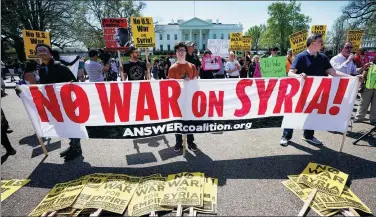  ?? MANDEL NGAN / AFP ?? Demonstrat­ors take part in a protest against the US bombings in Syria outside the White House grounds on Saturday in Washington. Similar protests took place across North America and in major European cities.
