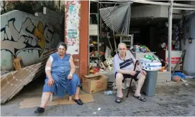  ??  ?? A woman injured in Tuesday’s blast beside her husband outside their damaged grocery in Beirut. Photograph: Aziz Taher/Reuters