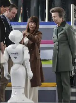  ?? ?? Princess Anne taking an interest in a robot at South West College.