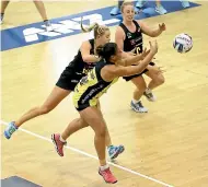  ??  ?? Central Pulse defender Renee Savai’inaea, foreground, competes for a loose ball with the Magic pair of Monica Falkner, left, and Sam Sinclair.