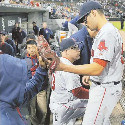  ?? AP PHOTO ?? ANOTHER QUALITY START: Joe Kelly is greeted in the dugout after being removed in the eighth inning of the Red Sox’ 3-1 win against the Mets yesterday in New York. Kelly improved to 8-6.