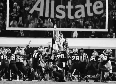  ?? JULIO AGUILAR/GETTY ?? Matthew Wright, #11 of the UCF Knights, kicks a field goal during the fourth quarter against the Cincinnati Bearcats on Nov. 17 in Orlando.