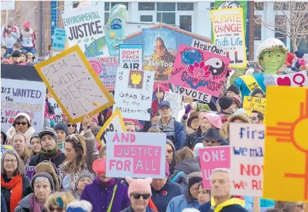  ?? GREG SORBER/JOURNAL ?? Signs of protest wave in a sea of thousands of people gathered for the Women’s March on Civic Plaza on Sunday.