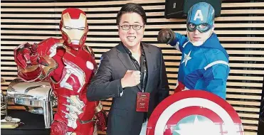  ??  ?? Exciting year: Tan with Marvel Avengers characters Iron Man and Captain America. He says the company hopes to deliver an exciting year to shareholde­rs.