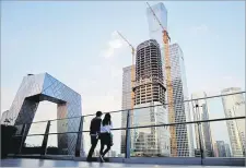  ?? Picture: REUTERS/THOMAS PETER ?? People look at the skyline of the Central Business District in Beijing, China.