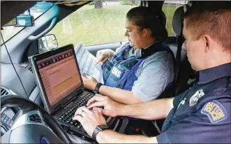  ?? TY GREENLEES / STAFF ?? Dayton Fire Department Addiction Resource Liaison/EMT Amy Dunkin (left) and Dayton Police Addiction Liaison Officer Jason Olson map out their day helping opioid addicts find treatment.