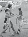  ?? RAMON ESPINOSA, AP ?? A family collects water in Bayamon, Puerto Rico.