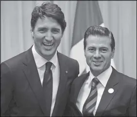  ?? CP PHOTO ?? Prime Minister Justin Trudeau (left) and Mexican President Enrique Pena Nieto renewed their commitment to NAFTA renegotiat­ion after absorbing the blow of the Trump administra­tion’s decision to impose potentiall­y debilitati­ng new tariffs on steel and...