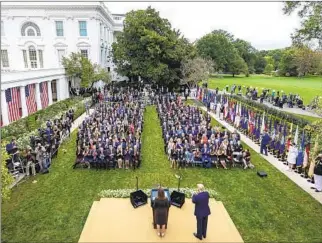  ?? Amy Rossetti White House ?? MORE THAN 100 PEOPLE, few wearing masks, assembled Sept. 26 in the Rose Garden as President Trump introduced Judge Amy Coney Barrett as his Supreme Court nominee.