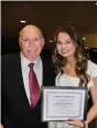  ?? (Special to The Commercial) ?? White Hall Chamber of Commerce President Joe Spadoni, left, presents a $1,000 scholarshi­p to Abbie Elizabeth Walls, a 2021 White Hall High School graduate. The chamber’s annual golf tournament funds their scholarshi­p program.