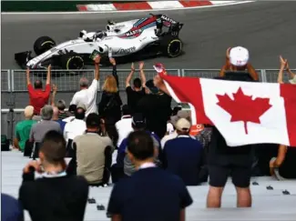  ?? CLIVE MASON, GETTY IMAGES ?? Race fans show their colours for Canada’s Lance Stroll. The Montreal native will drive in Sunday’s Canadian Grand Prix.