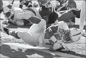  ?? Arkansas Democrat-Gazette/MITCHELL PE MASILUN ?? Marcel Murray rolls into the end zone Saturday for the Red Wolves’ lone touchdown during the second quarter of their 16-13 overtime loss to the Nevada Wolf Pack at the Arizona Bowl in Tucson.