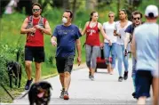  ?? CURTIS COMPTON / CCOMPTON@AJC.COM ?? People venture onto the Beltline on Sunday despite a stayat-home order in Atlanta. “It’s very clear that the messaging is still not resonating with many people,” Mayor Keisha Lance Bottoms said.