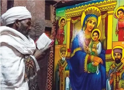  ?? GETTY IMAGES ?? A priest in prayer in the Bet Madane Alem Orthodox church in Lalibela, Ethiopia.