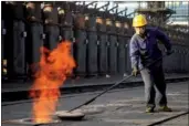  ?? ZHANG CHAOQUN / XINHUA ?? A worker prepares for coking coal production at a plant in Wuhai, the Inner Mongolia autonomous region.