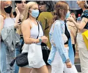  ??  ?? Shoppers on Oxford Street yesterday, as the new rule came into force. A shop on Regent Street offers face masks for sale, top