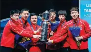  ?? XINHUA ?? Left: China men’s team players and coach Liu Guozheng (third left) pose with the trophy after winning the ITTF World Team Championsh­ips title on Sunday. Right: Former head coach Liu Guoliang (right) serves as a guest commentato­r for Team China’s...