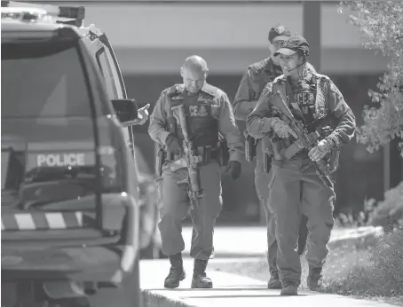  ?? DAX MELMER ?? Members of the OPP tactics and rescue unit leave L’Essor secondary school on Tuesday after responding to reports just before noon that a student with a knife was chasing people. Police surrounded the building before moving inside, but found no weapon.