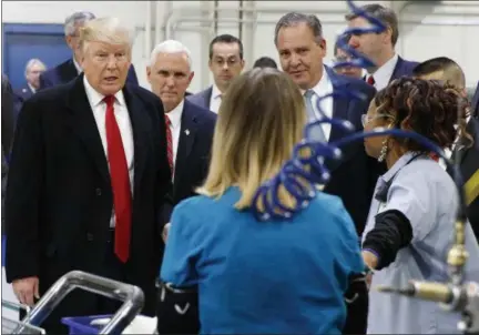  ?? EVAN VUCCI — ASSOCIATED PRESS ?? President-elect Donald Trump and Vice President-elect Mike Pence talk to workers at the Carrier Corp. plant in Indianapol­is on Thursday.