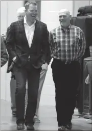  ?? JOHN BAZEMORE / The Associated Press ?? Chipper Jones (left) walks with Braves manager Brian Snitker as he arrives for a press conference on Tuesday at SunTrust Park.