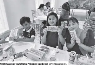  ?? DFA ?? ATTENDEES enjoy treats from a Philippine-based quick-serve restaurant