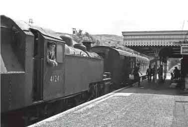  ?? Keith Widdowson/ANISTR.COM ?? If ever there is an idyllic scene long lost in time, it is this. Ivatt ‘2MT’ 2-6-2T No 41249 rests from its exertions at Torrington after working the singlecoac­h 10.52am service from Halwill Junction on Saturday, 18 July 1964. Trains on this line could operate as mixed so there were times when passengers, usually in a Bulleid brake composite, could find themselves involved in a shunt, with livestock and other goods sharing the same train. Whether it was worth paying the extra to sit on your own in first class as opposed to doing the same in second is open to question!