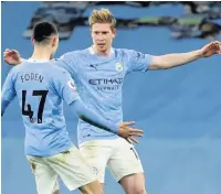  ??  ?? PHIL YER BOOTS De Bruyne celebrates City’s fifth with Foden