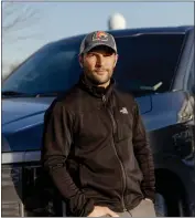  ?? SYLVIA JARRUS — THE NEW YORK TIMES ?? Michael Puglia leans against the Ford F-150lightni­ng electric pickup truck that he purchased last year, at home in Dexter, Mich., on Feb. 3.