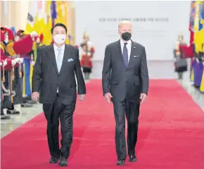  ?? REUTERS ?? US President Joe Biden and his South Korean counterpar­t Yoon Suk-yeol arrive for a state dinner at the National Museum of Korea in Seoul on Saturday.