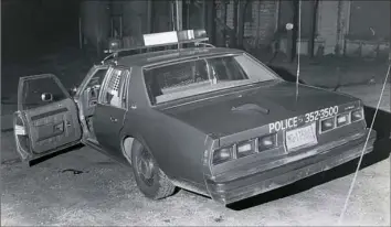  ??  ?? The police car of Saxonburg Chief Gregory Adams with his necktie on the trunk, at the scene of the fatal shooting in Saxonburg on Dec. 4, 1980.