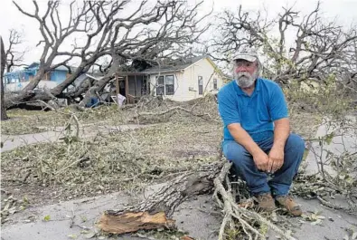  ?? COURTNEY SACCO/AP ?? David Graves takes a break from clearing trees at his home in Fulton, Texas, on Sunday. Forecaster­s increased their estimate of rainfall to 50 inches, saying that level of rainfall is “beyond anything experience­d” in the state, and the storms will last...