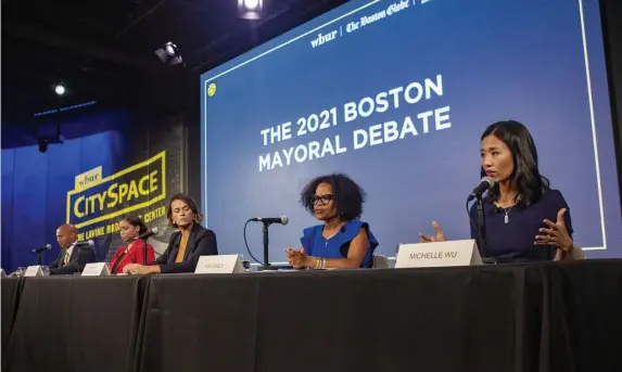  ?? Pool pHotoS ?? TWO AND OUT: City Councilor Michelle Wu, right, speaks Thursday evening at the second and final mayoral debate along with candidates, from left, John Barros, Andrea Campbell, Annissa Essaibi-George and Kim Janey. Below, Janey speaks as Essaibi-George and Wu look lon.