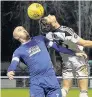  ??  ?? Llandudno’s Sam Hart wins this aerial challenge with Gary Taylor Fletcher.