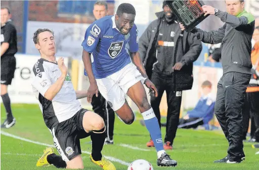  ??  ?? ●● Adriano Moke skips past Dover’s Nick Deverdics during a starring role for the winger