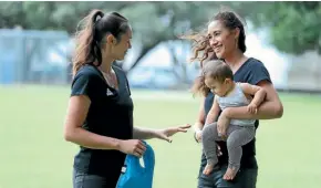  ??  ?? Maria Folau holds Ameliarann­e Ekenasio’s baby boy.