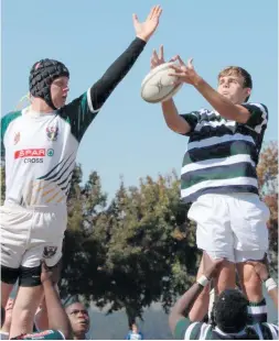  ??  ?? Heinrich Maritz from SLC jumps for the ball in the line out.