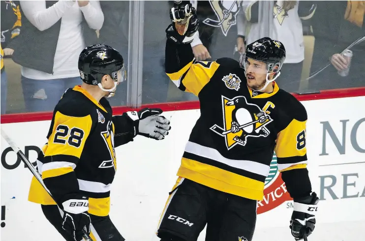  ?? — AP FILES ?? Ian Cole, left, celebrates with Sidney Crosby after the Penguins captain scored against Ottawa in recent NHL action. At 29, Crosby is still the game’s best player.