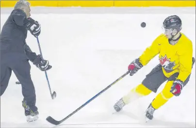  ?? CP PHOTO ?? Canadian national junior team prospect Dillon Dube (right) takes part in a shot-blocking drill with head coach Dominique Ducharme on the first day of selection camp for the 2018 World Junior Hockey Championsh­ip in St. Catharines, Ont., on Tuesday.