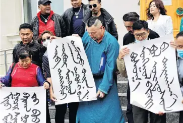  ?? PHOTO: REUTERS ?? Demonstrat­ors, holding signs with Mongolian script, protest against China’s changes to school curriculum­s that remove Mongolian language from core subjects, outside the Mongolian Ministry of Foreign Affairs in Ulaanbaata­r.