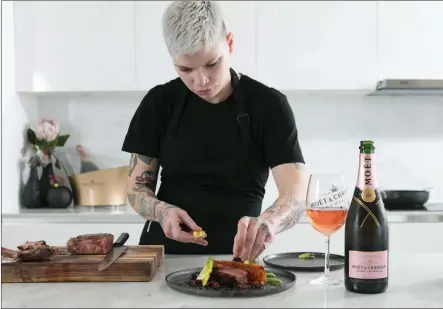  ??  ?? MOUTHWATER­ING: Chef Ash Heeger preparing honey cured beef to be served with a chilled and fruity Moët &amp; Chandon Rosé.