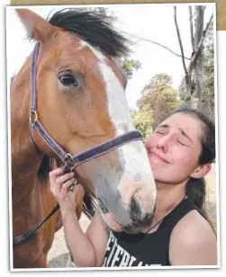  ??  ?? TOUGH DAY: Jade Gonzalez, who fled the fire with her horses, struggles to contain her emotions at the local oval.