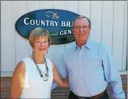  ?? DAN SOKIL — DIGITAL FIRST MEDIA ?? Co-owners Trish and Ed Burkholder pose outside the Country Bride and Gent store on Sumneytown Pike in Upper Gwynedd on Monday.