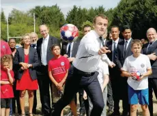  ?? — Reuters ?? French President Emmanuel Macron visits the recreation­al centre for children in Moisson, France, on Thursday.