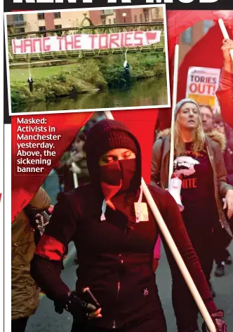  ??  ?? Masked: Activists in Manchester yesterday. Above, the sickening banner