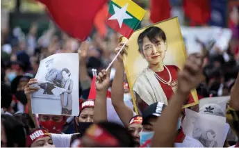  ?? — AFP file photo ?? Protesters hold images of detained Suu Kyi and a flag of Myanmar during a demonstrat­ion outside the Embassy of Myanmar in Bangkok.